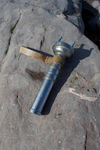 Siebe Gorman diver torch AP 4456 – angled side view on rock with leather strap