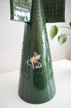 Close-up of riveted tail fin design on decorative green bomb fin table