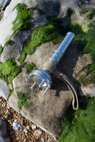 Vintage Siebe Gorman diver torch AP 4456 – front view on rock
